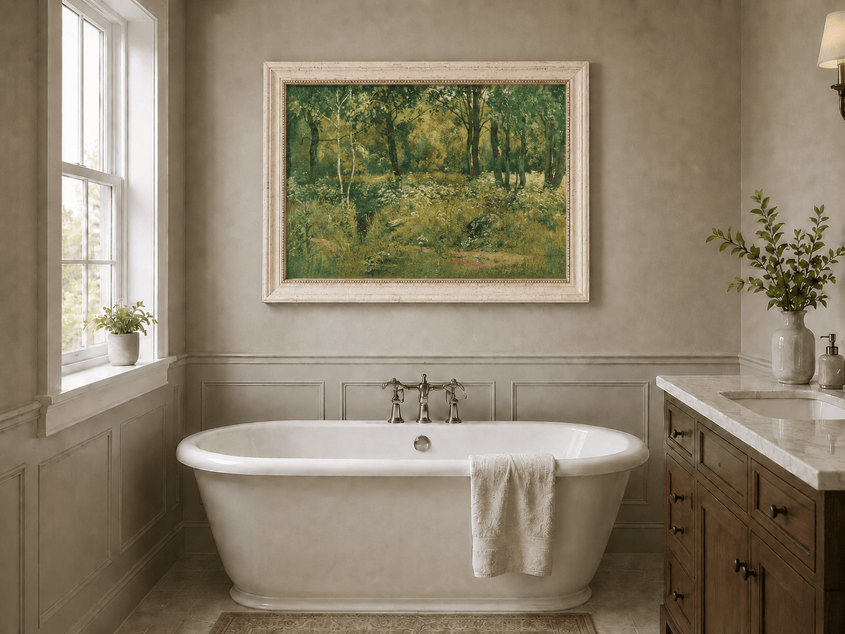 Framed hand-painted sunlit forest clearing oil painting with tall trees and golden undergrowth displayed above a freestanding bathtub.