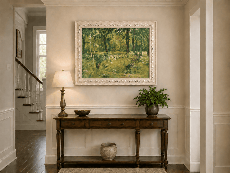 Framed hand-painted sunlit forest clearing oil painting with tall trees and golden undergrowth displayed above an entryway console table.