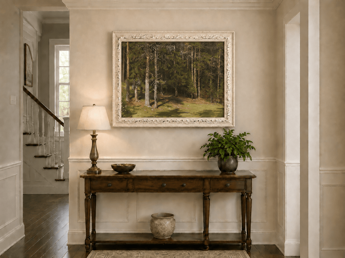 Framed hand-painted sunlit forest glade oil painting with a peaceful woodland clearing displayed above an entryway console table.