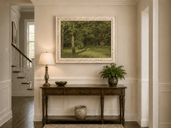 Framed hand-painted sunlit forest glade oil painting with colorful wildflowers displayed above an entryway console table.