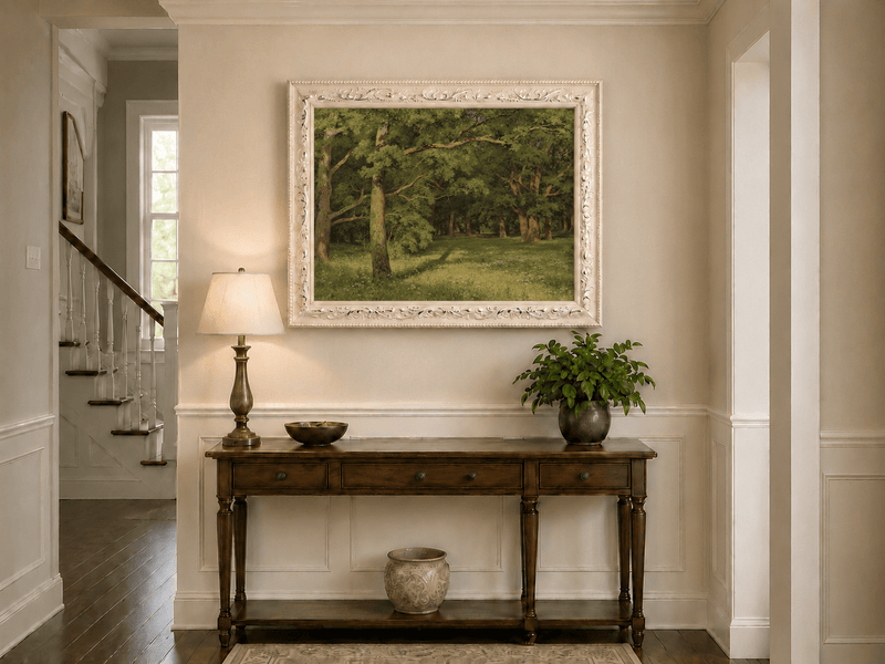 Framed hand-painted sunlit forest glade oil painting with colorful wildflowers displayed above an entryway console table.