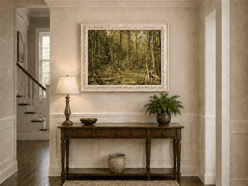 Framed hand-painted sunlit forest interior oil painting with fallen trees and dense foliage displayed above an entryway console table.