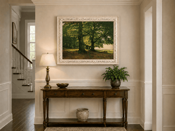 Framed hand-painted sunlit forest oil painting with two large spreading trees displayed above an entryway console table.