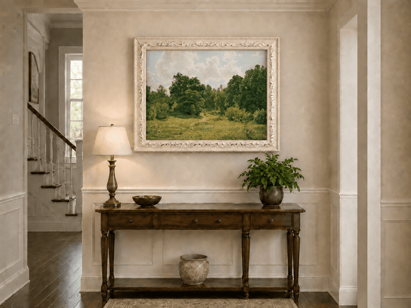 Framed hand-painted sunlit forest path oil painting through an open green clearing displayed above an entryway console table.