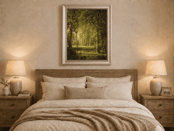 Framed hand-painted sunlit forest pond oil painting with tall trees and golden reflections displayed above a wooden bed in a neutral bedroom.