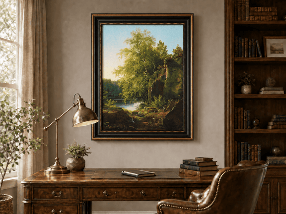 Framed hand-painted sunlit lakeside oil painting with rocks and leafy birch trees displayed above a traditional home office desk.