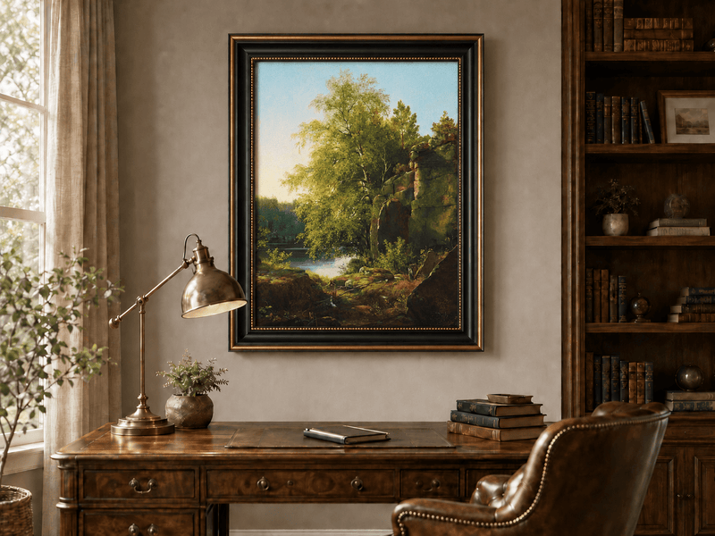 Framed hand-painted sunlit lakeside oil painting with rocks and leafy birch trees displayed above a traditional home office desk.