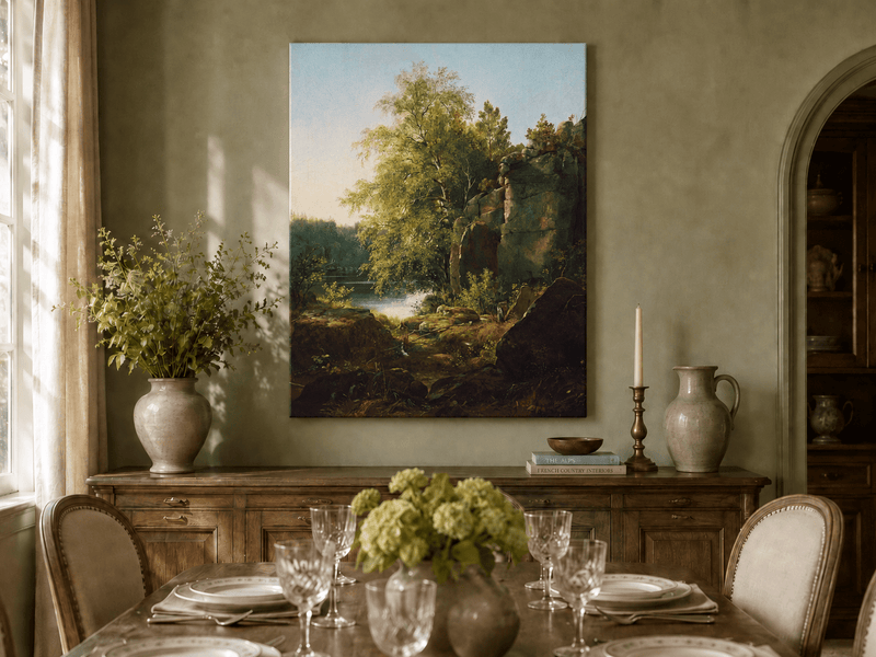 Unframed hand-painted sunlit lakeside oil painting with rocks and leafy birch trees displayed above a formal dining table.