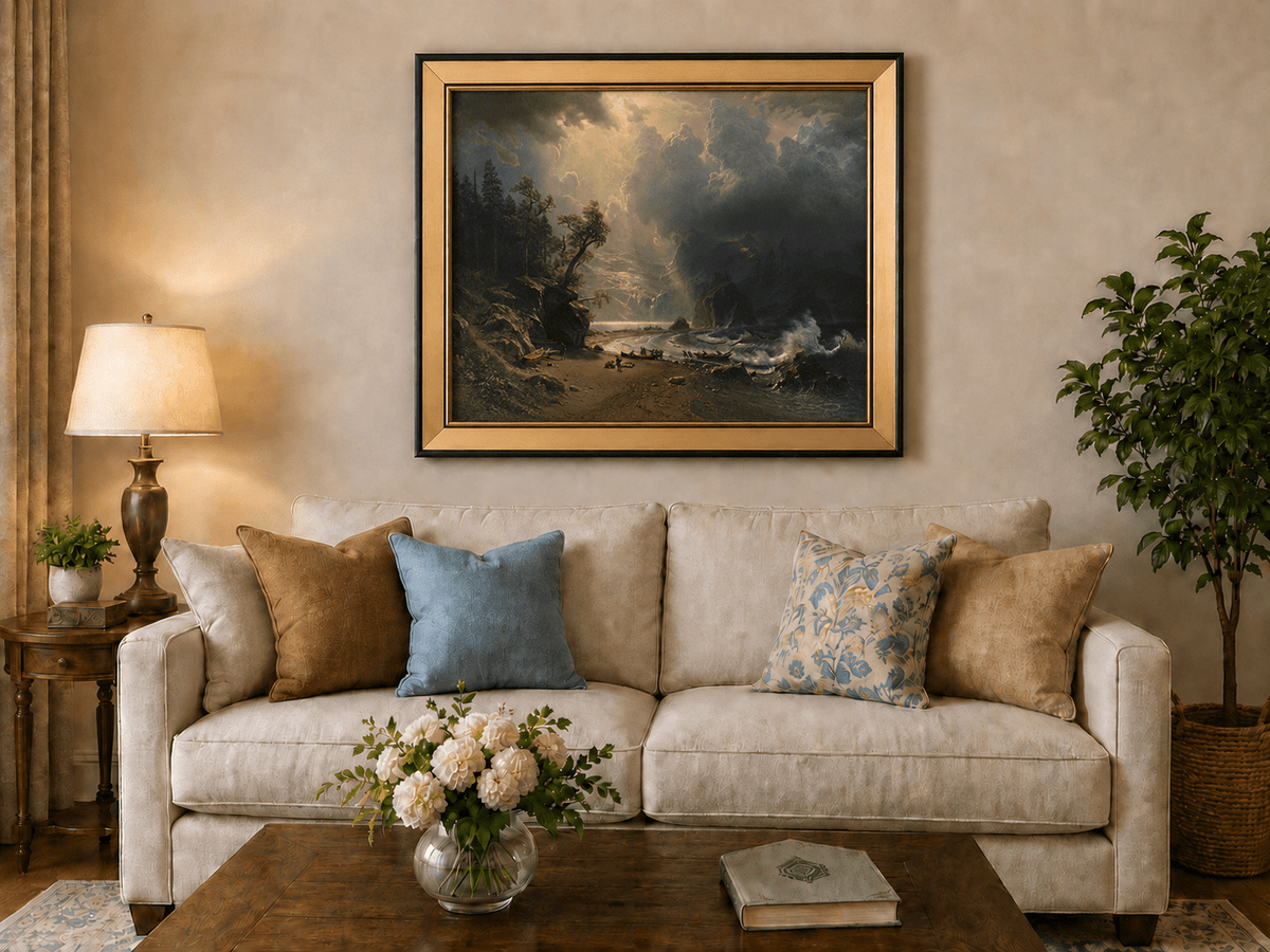 Framed hand-painted sunlit mountain valley oil painting beneath dramatic storm clouds displayed above a neutral living room sofa.