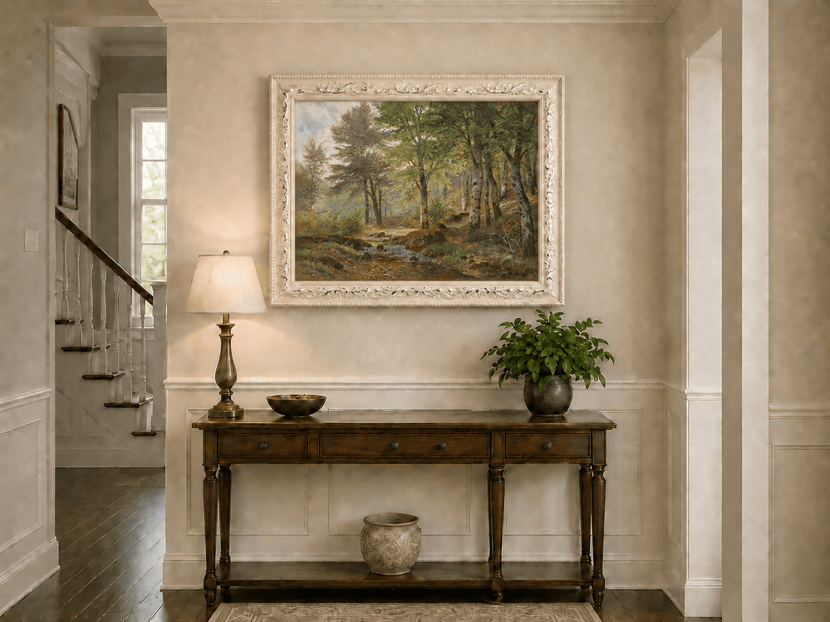 Framed hand-painted sunlit woodland stream oil painting with slender birch trees displayed above an entryway console table.