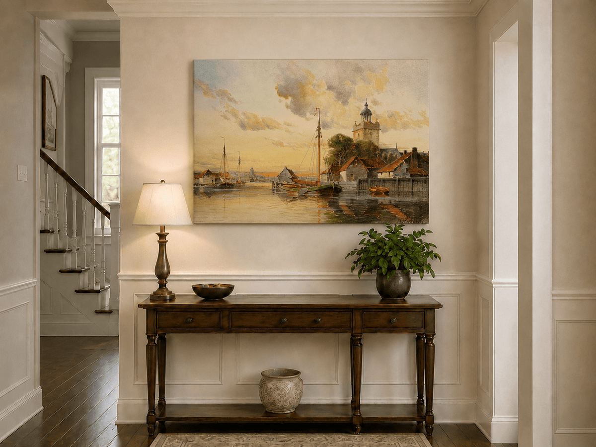 Unframed hand-painted sunset harbor oil painting with sailboats and a waterfront tower displayed above an entryway console table.