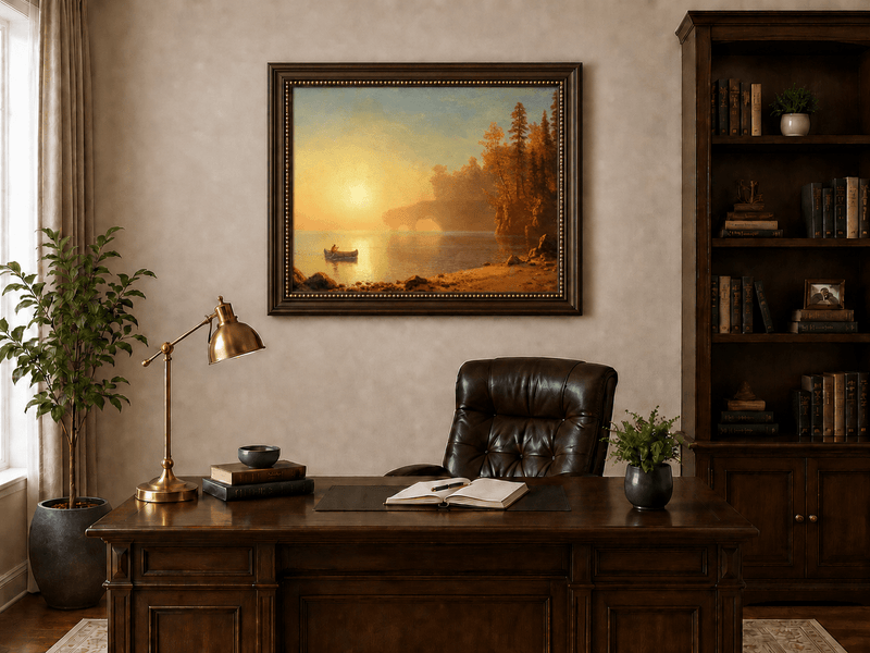 Framed hand-painted sunset lake oil painting with a canoe on glowing water displayed above a traditional home office desk.