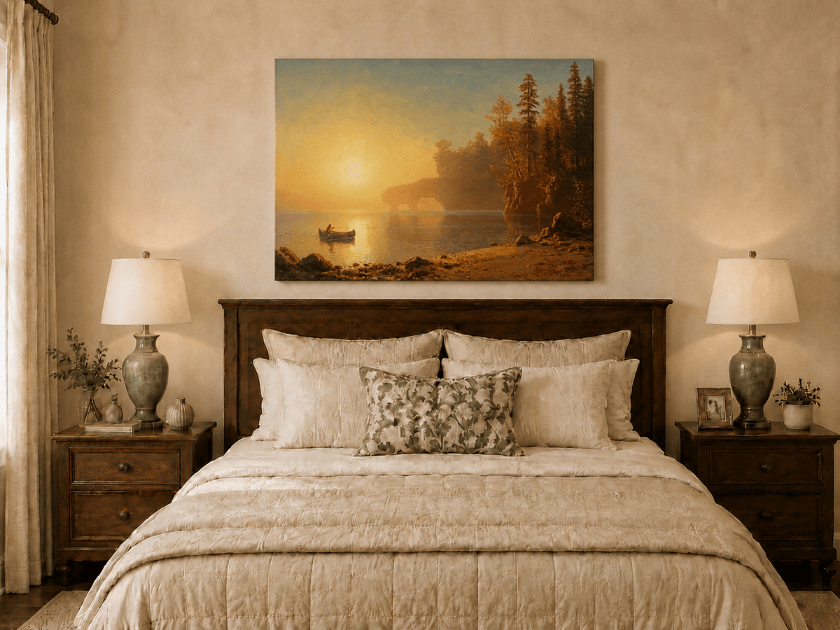 Unframed hand-painted sunset lake oil painting with a canoe on glowing water displayed above a wooden bed in a neutral bedroom.