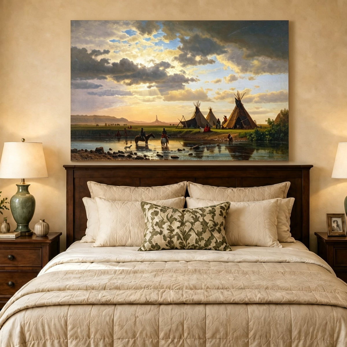 Unframed hand-painted sunset river camp oil painting with tipis and riders crossing the water displayed above a wooden bed in a neutral bedroom.