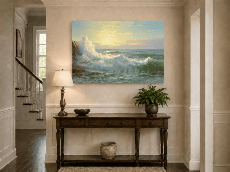 Unframed hand-painted sunset seascape oil painting with luminous crashing waves displayed above an entryway console table.