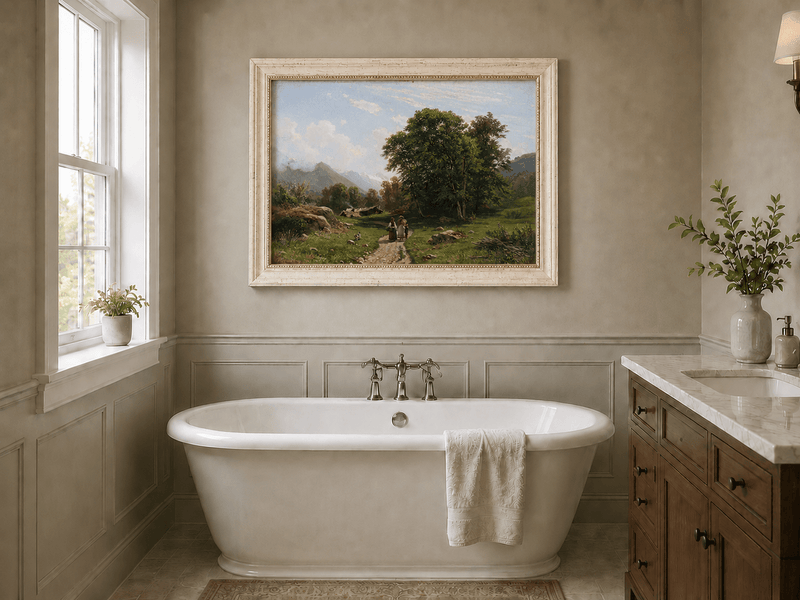 Framed hand-painted Swiss landscape oil painting with a country path, trees and distant peaks displayed above a freestanding bathtub.