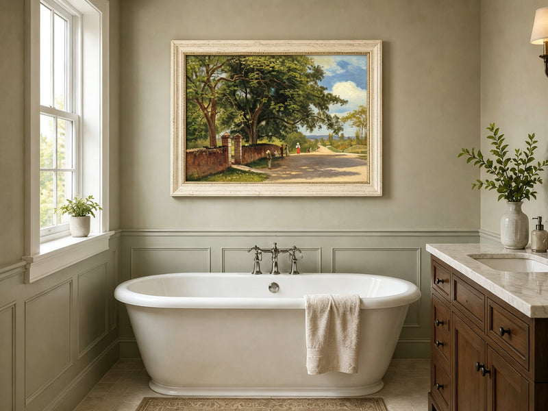 Framed hand-painted country road oil painting with figures beneath broad leafy trees displayed above a freestanding bathtub.