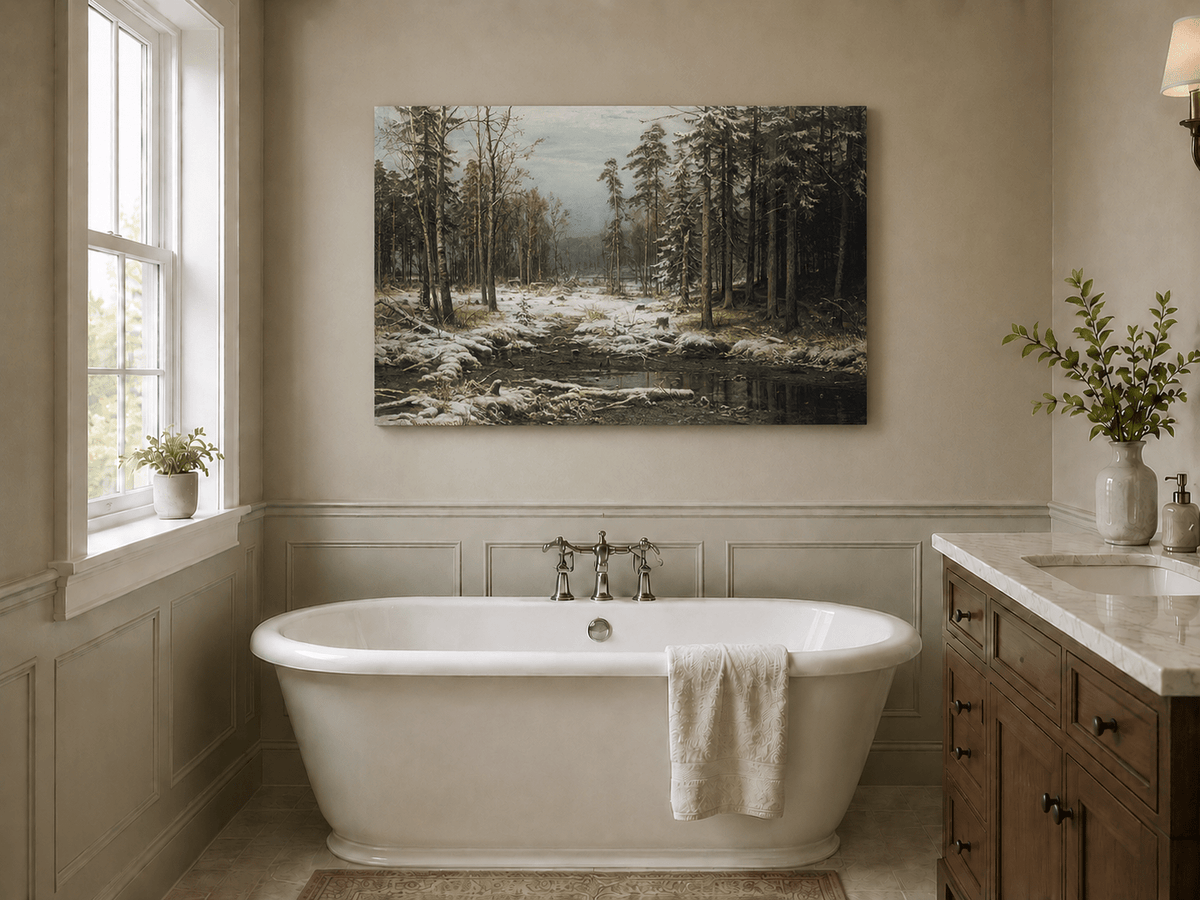 Unframed hand-painted winter forest oil painting with a flowing stream through snowy woods displayed above a freestanding bathtub.