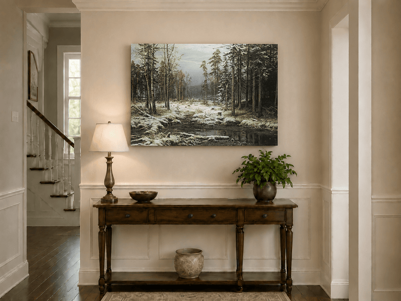 Unframed hand-painted winter forest oil painting with a flowing stream through snowy woods displayed above an entryway console table.