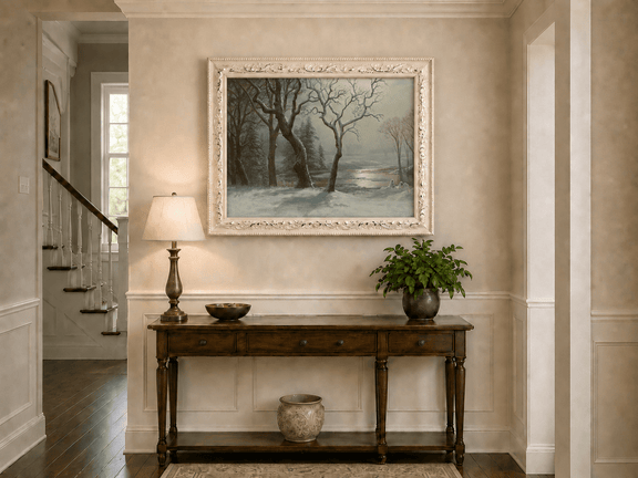 Framed hand-painted winter river oil painting with bare trees in a snowy forest displayed above an entryway console table.