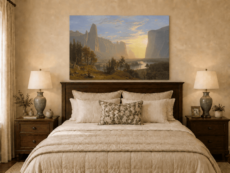 Unframed hand-painted Yosemite Valley oil painting with towering cliffs in golden light displayed above a wooden bed in a neutral bedroom.