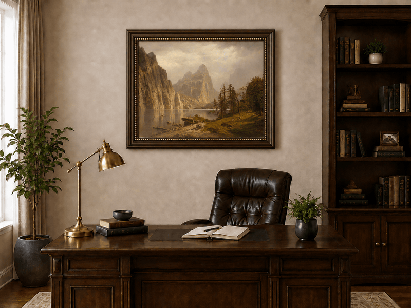 Framed hand-painted Yosemite Valley oil painting with the Merced River and mountain cliffs displayed above a traditional home office desk.