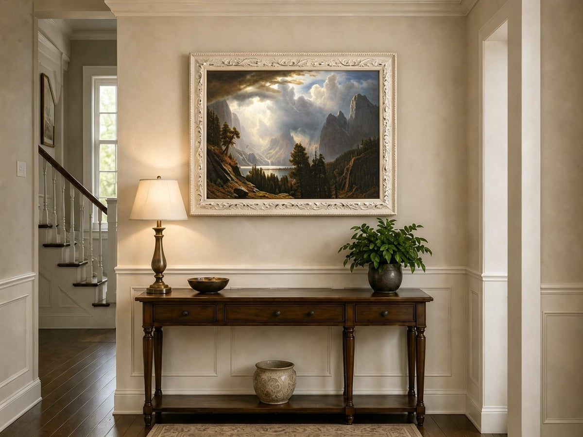 Framed hand-painted Yosemite Valley oil painting with storm clouds and dramatic sunbeams displayed above an entryway console table.