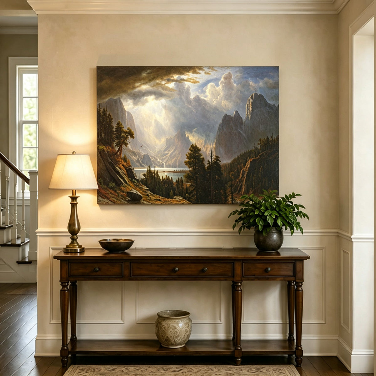 Unframed hand-painted Yosemite Valley oil painting with storm clouds and dramatic sunbeams displayed above an entryway console table.