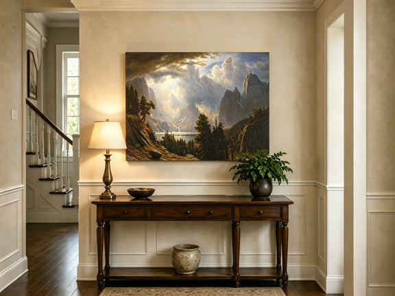 Unframed hand-painted Yosemite Valley oil painting with storm clouds and dramatic sunbeams displayed above an entryway console table.
