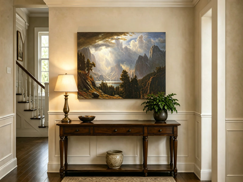Unframed hand-painted Yosemite Valley oil painting with storm clouds and dramatic sunbeams displayed above an entryway console table.