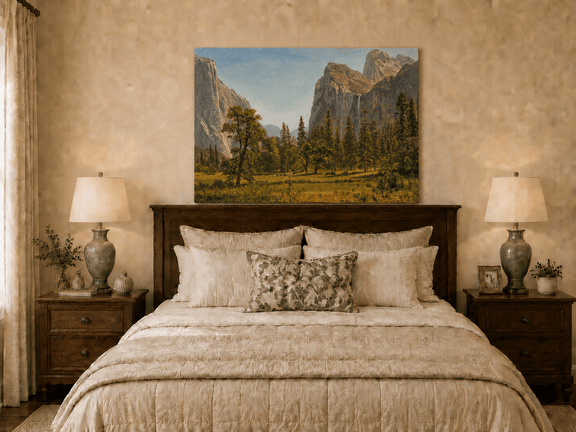 Unframed hand-painted Yosemite Valley oil painting with a waterfall and towering granite cliffs displayed above a wooden bed in a neutral bedroom.