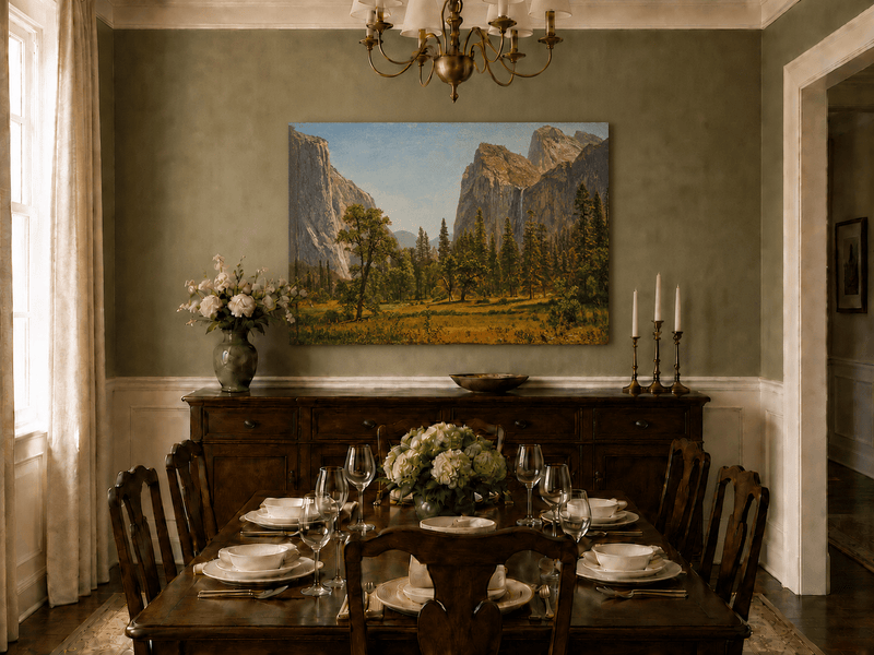 Unframed hand-painted Yosemite Valley oil painting with a waterfall and towering granite cliffs displayed above a formal dining table.