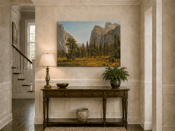 Unframed hand-painted Yosemite Valley oil painting with a waterfall and towering granite cliffs displayed above an entryway console table.