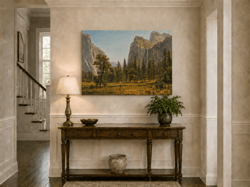 Unframed hand-painted Yosemite Valley oil painting with a waterfall and towering granite cliffs displayed above an entryway console table.