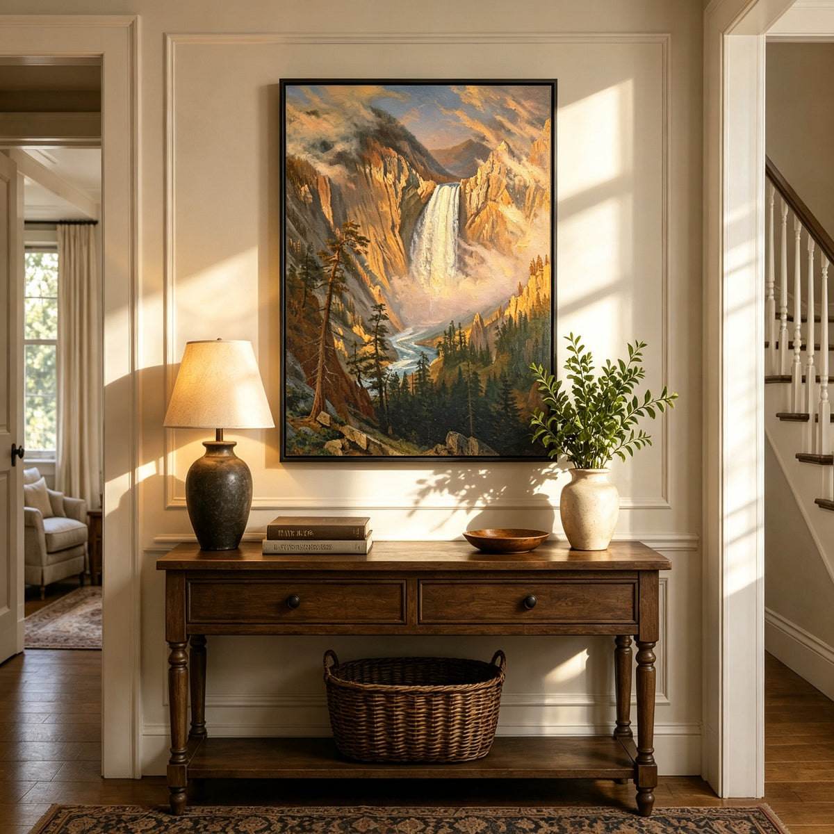 Framed hand-painted Yosemite waterfall oil painting with sunlit mist and granite cliffs displayed above an entryway console table.